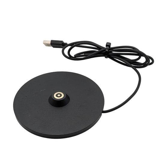 Black magnetic charger with USB cable on a white background
